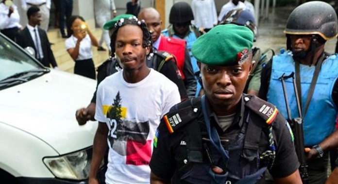 Naira Marley and A Nigerian Police Official